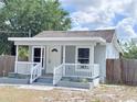 Inviting front porch with white railings and steps, perfect for relaxing outdoors at 804 Whitehurst Rd, Plant City, FL 33563