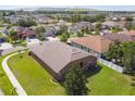 Overhead shot of house with spacious fenced yard in a residential area surrounded by other homes and mature trees at 8437 White Poplar Dr, Riverview, FL 33578