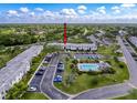 Aerial view of condo community with swimming pool, parking, and green spaces at 110 W Cypress Ct, Oldsmar, FL 34677
