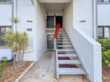 Exterior stairway leads to the front door of the condo unit at 110 W Cypress Ct, Oldsmar, FL 34677