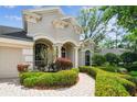 Close-up of a lovely home with a well-maintained front yard and architectural details that highlight its unique character at 1655 Eagles Reach, Tarpon Springs, FL 34688