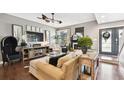 Beautiful living room featuring a fireplace, large TV, hardwood floors, and comfortable seating arrangements at 166 E Davis Blvd, Tampa, FL 33606