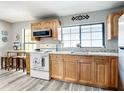 Kitchen with stainless steel appliances, wood cabinets, and plenty of natural light at 2425 Auburn S St, St Petersburg, FL 33712