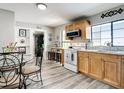 Bright kitchen with stainless steel appliances, wood cabinets, and wood-look flooring at 2425 Auburn S St, St Petersburg, FL 33712