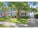 Beautiful exterior showcasing a charming home with landscaped yard and a tree that provides ample shade at 2512 W Sunset Dr, Tampa, FL 33629