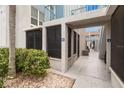 Exterior view of condo units with private courtyards, stone accents, and well-manicured landscaping at 253 Rex Pl # B, Madeira Beach, FL 33708