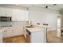 Bright kitchen with white cabinetry, a mosaic backsplash, and a breakfast bar at 27130 Firebush Dr, Wesley Chapel, FL 33544