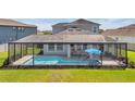 Relaxing screened-in pool area provides a private outdoor retreat with ample space for seating and recreation at 28683 Lucero Ln, Wesley Chapel, FL 33543