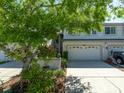 Charming townhome featuring a two-car garage and a well-maintained lawn at 2983 Covewood Pl, Clearwater, FL 33761