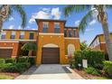 Beautiful multi-story townhome with a private garage, a well-manicured lawn and mature landscaping at 30130 Mossbank Dr, Wesley Chapel, FL 33543