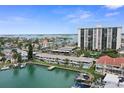 Expansive aerial view showcasing waterfront condos, boat docks, and surrounding ocean at 400 Larboard Way # 103, Clearwater, FL 33767