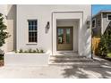 Inviting entrance with a double door, enhanced by stylish sconces and verdant landscaping at 413 W Park Ave # 1, Tampa, FL 33602