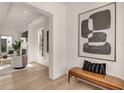 Bright hallway with hardwood floors, a stylish bench, and modern artwork at 413 W Park Ave # 1, Tampa, FL 33602