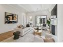 Bright living room with elegant furniture, fireplace, and sliding glass doors at 413 W Park Ave # 1, Tampa, FL 33602