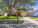 Charming home with a well-manicured lawn and mature tree providing shade at 4606 Copper Ln, Plant City, FL 33566