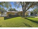 Charming home with a well-manicured lawn and mature tree providing shade at 4606 Copper Ln, Plant City, FL 33566