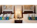 Close-up of hotel bedroom showcasing the headboards and patterned accent pillows at 5500 Gulf Blvd # 4228, St Pete Beach, FL 33706