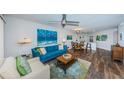 Open living area with modern decor, sleek flooring, and a view to dining area at 6141 Bahia Del Mar Blvd # 129, St Petersburg, FL 33715