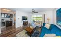 Living room features modern decor, sleek flooring, and sliding doors to the outside view at 6141 Bahia Del Mar Blvd # 129, St Petersburg, FL 33715