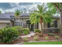 Charming home featuring manicured landscaping, stone accents, and an inviting front entrance at 6205 Ibispark Dr, Lithia, FL 33547