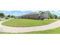 Expansive corner lot featuring a well-maintained lawn and sidewalks at 7019 Wiseman Run Dr, Sun City Center, FL 33573