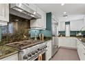 Well-appointed kitchen featuring custom cabinets, stone countertops, and stainless steel appliances at 720 Brightwaters Ne Blvd, St Petersburg, FL 33704