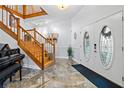 Welcoming foyer featuring marble floors, a staircase, and an elegant front door with decorative glass at 830 Pinellas Bayway S, St Petersburg, FL 33715