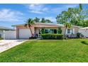 Charming single-story home with well-maintained lawn, lush landscaping, and inviting curb appeal at 940 43Rd Ne Ave, St Petersburg, FL 33703