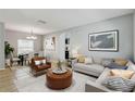 Stylishly furnished living room with modern decor, a comfortable sofa, and an adjacent dining area at 10524 White Peacock Pl, Riverview, FL 33578
