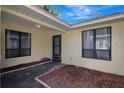 Enclosed outdoor courtyard area with mature landscaping, accessed directly from the home at 107 Parkside Colony Dr, Tarpon Springs, FL 34689