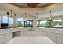 Bright, open kitchen offers counter seating, ample storage, and scenic views from large windows at 109 Wateredge Ct, Safety Harbor, FL 34695