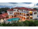 Expansive backyard featuring a private pool, spa, covered patios, and a spiral staircase at 109 Wateredge Ct, Safety Harbor, FL 34695