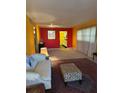 View of the living room with colorful walls, rug, and an open layout at 1220 57Th N St # 204C, St Petersburg, FL 33710