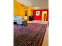 View of the living room showcasing the rug, furniture, and colorful walls at 1220 57Th N St # 204C, St Petersburg, FL 33710
