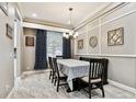 Formal dining room features crown molding, decorative wall and table decorations, and neutral tones at 12525 Sparkleberry Rd, Tampa, FL 33626