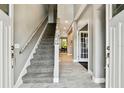 Welcoming foyer with tile flooring, staircase, and natural light creating a bright and airy entrance to the home at 12525 Sparkleberry Rd, Tampa, FL 33626