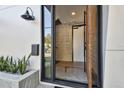 Stylish front door with glass pane, black hardware, and neutral colored concrete block at 1312 W Azeele St # 2, Tampa, FL 33606