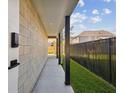 Side yard featuring concrete block and modern fence at 1312 W Azeele St # 2, Tampa, FL 33606