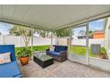 Cozy screened patio featuring a comfortable seating area and a view of the fenced backyard at 1318 Crimson Clover Ln, Wesley Chapel, FL 33543