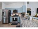 Modern kitchen featuring stainless steel appliances, granite countertops, and stylish cabinetry at 1601 14Th W St, Palmetto, FL 34221