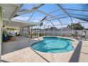 Inviting in-ground pool within a screened enclosure, perfect for relaxing and entertaining at 1601 14Th W St, Palmetto, FL 34221