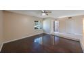 Bright living room showcasing dark hardwood floors, a ceiling fan, and ample natural light at 2205 Belleair Rd # A24, Clearwater, FL 33764