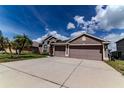 Lovely home with a spacious driveway and a well-maintained lawn at 2310 Wood Pointe Dr, Holiday, FL 34691