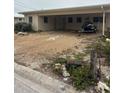 Modest single-story home with gravel yard and covered parking showing front entrance at 249 144Th Ave, Madeira Beach, FL 33708