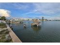 Scenic waterfront view with dock, boats, and tranquil water, showcasing the serene coastal living at 249 144Th Ave, Madeira Beach, FL 33708