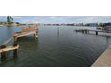 Picturesque waterfront view featuring a weathered dock, serene water, and distant cityscape in a relaxing setting at 249 144Th Ave, Madeira Beach, FL 33708