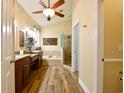 Bright bathroom with a soaking tub, separate shower, dual sinks, and wood-look flooring, exuding luxury at 30623 Bittsbury Ct, Wesley Chapel, FL 33543