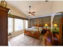 Cozy bedroom with a four-poster bed, soft rug, and plenty of natural light, creating a peaceful retreat at 30623 Bittsbury Ct, Wesley Chapel, FL 33543