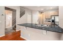 Open kitchen area with granite countertops, breakfast bar, and stainless steel appliances at 3219 Gianna Way, Land O Lakes, FL 34638