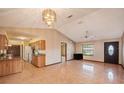Living room featuring high ceilings, tile floors, an updated light fixture and ceiling fan at 34796 Hibiscus St, Dade City, FL 33525